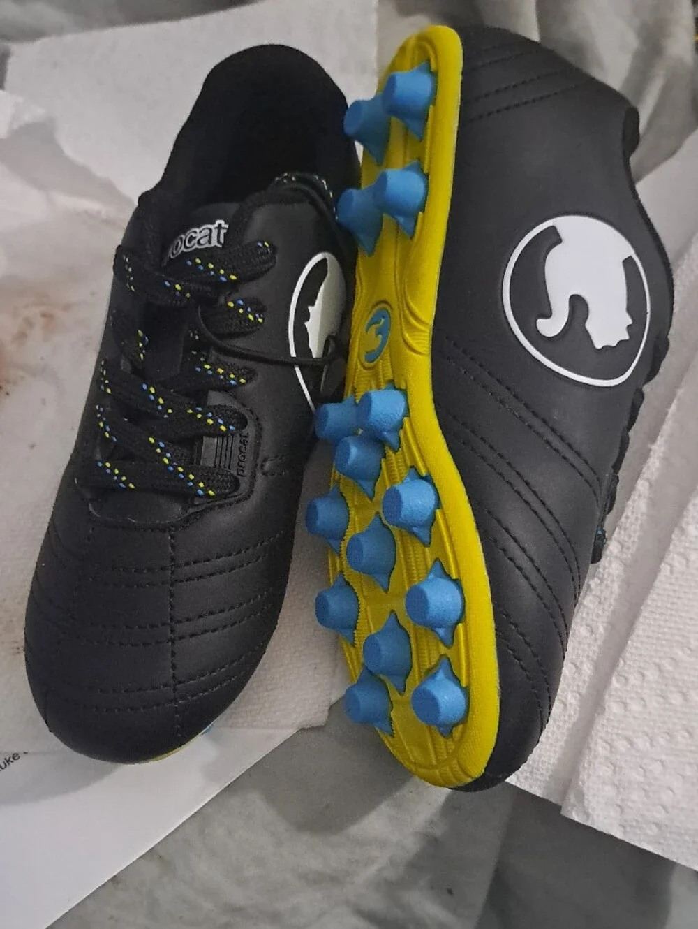 Puma Kids Black Soccer Cleats with Yellow Sole and Blue Studs